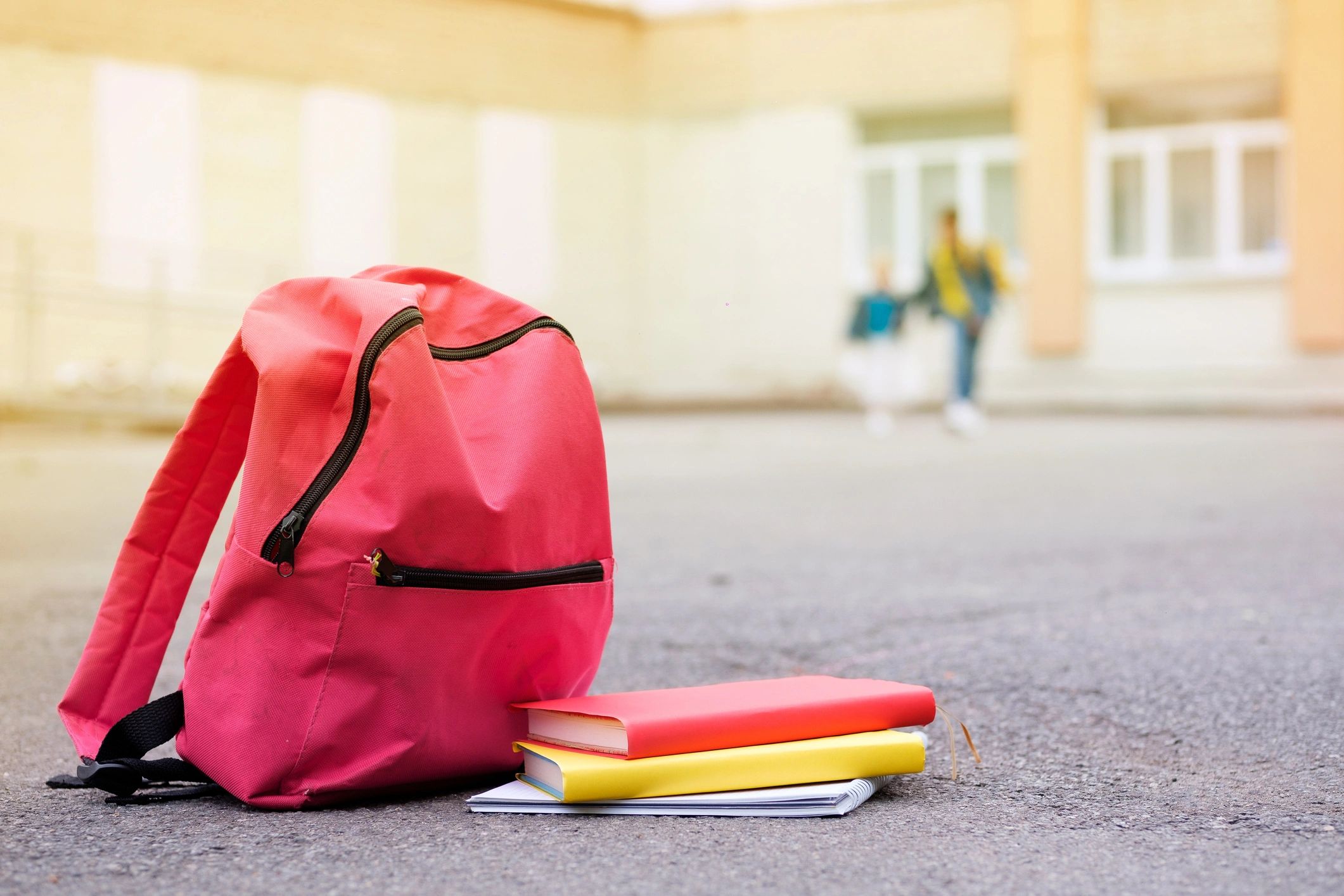 Colorful school books and backpack for learning support