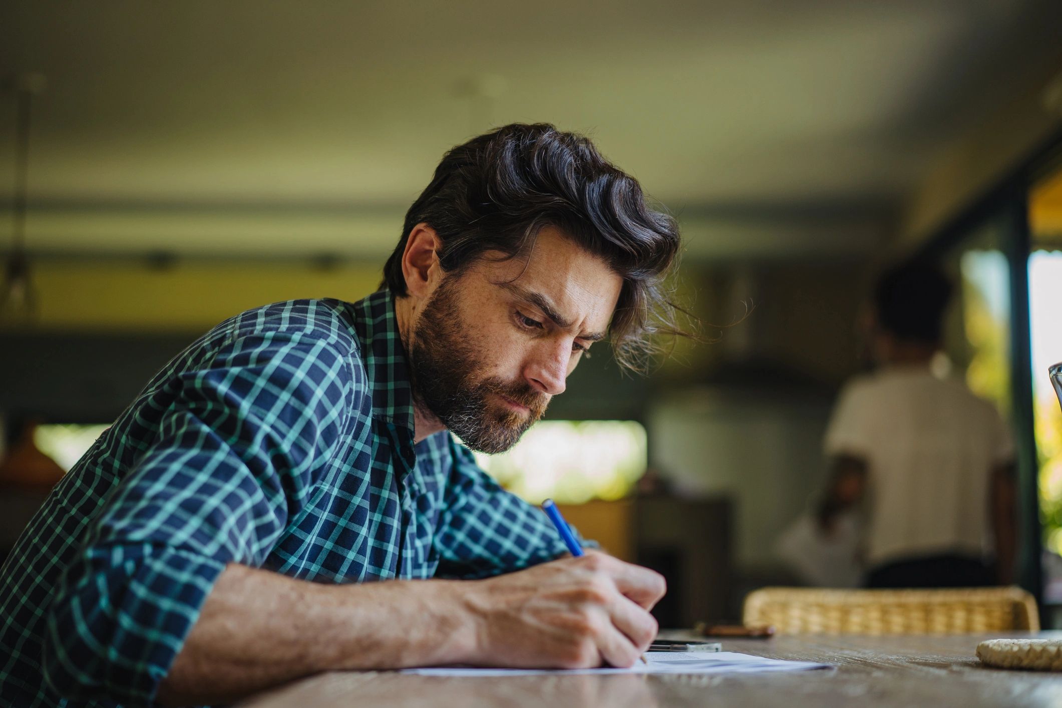 Author writing notes at a desk