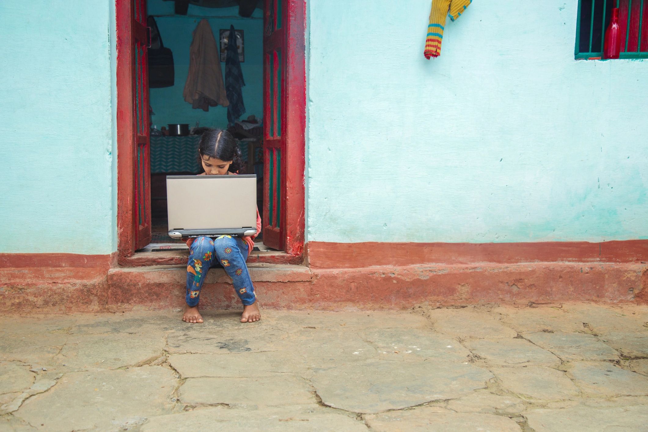 School girl studying online with a laptop at home