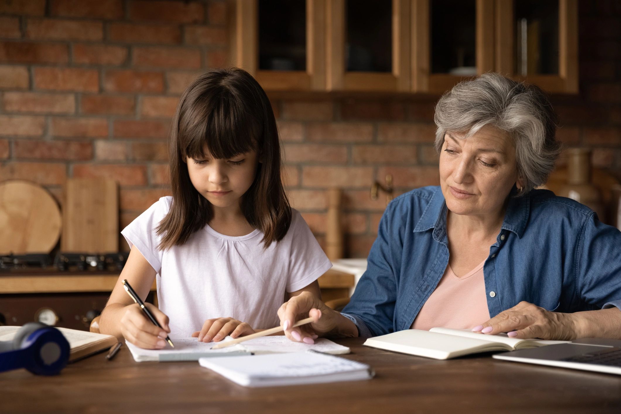 Adult guiding a child through study work at home