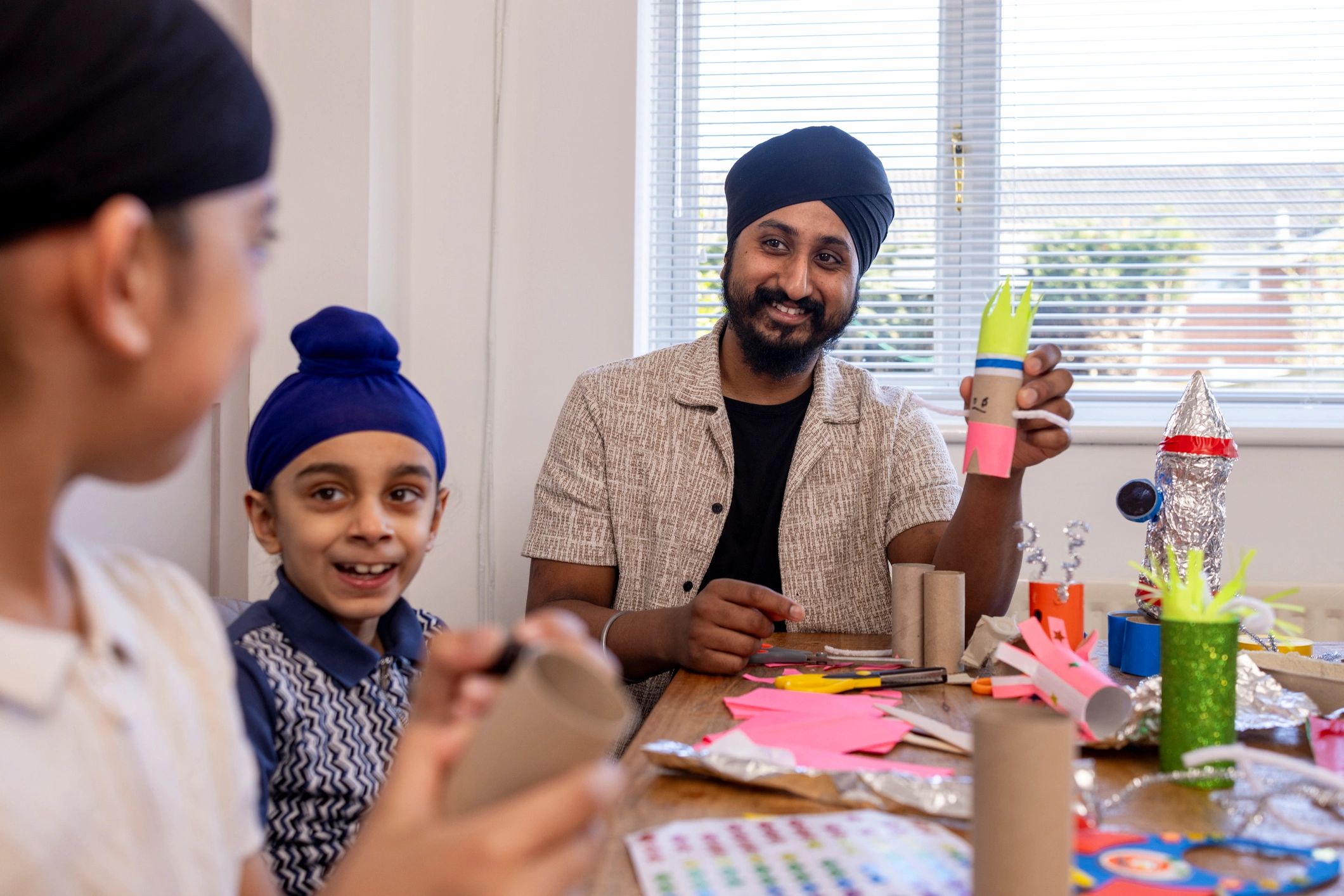 Parent supporting children in a creative learning activity