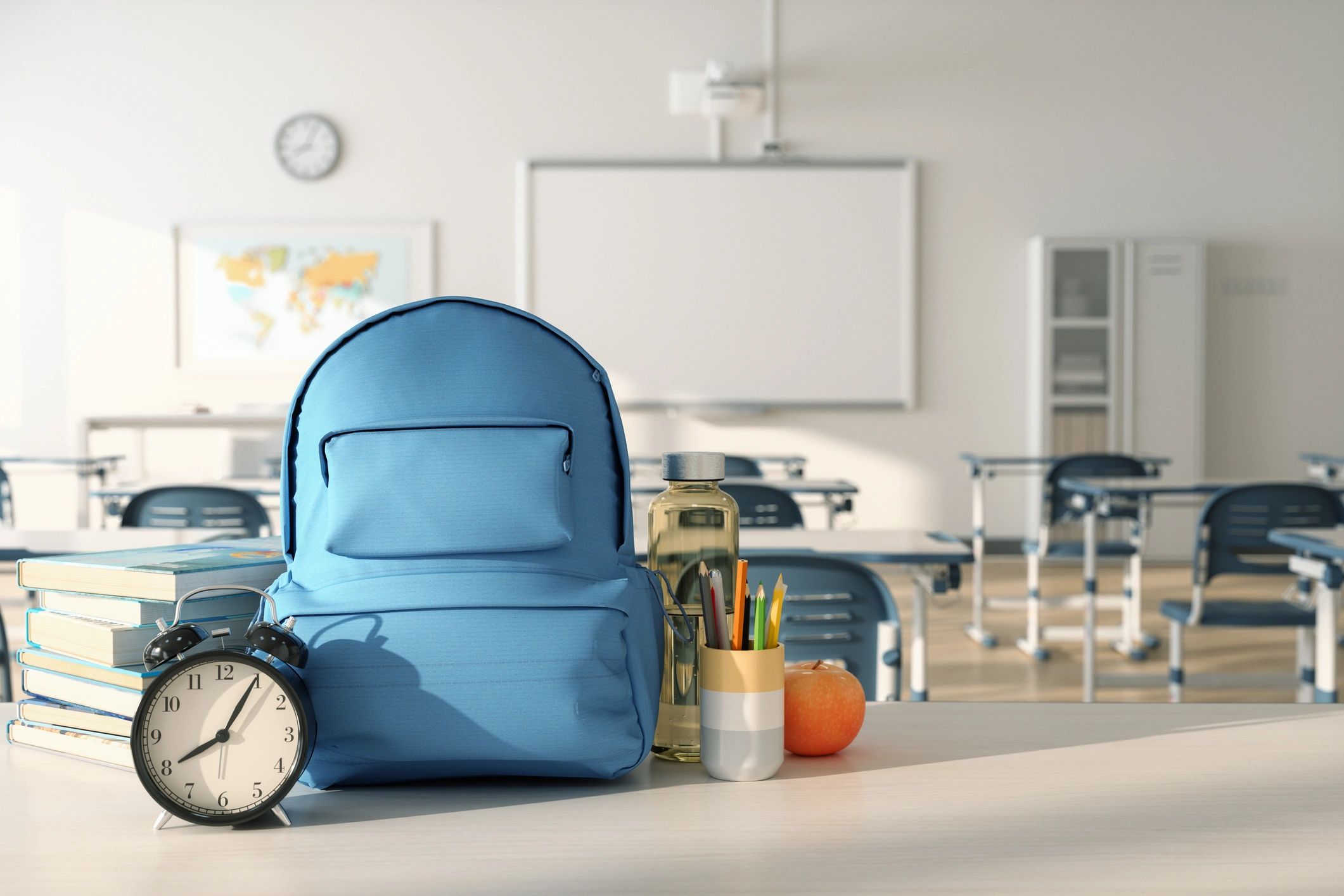 Educational books and school supplies on a classroom desk