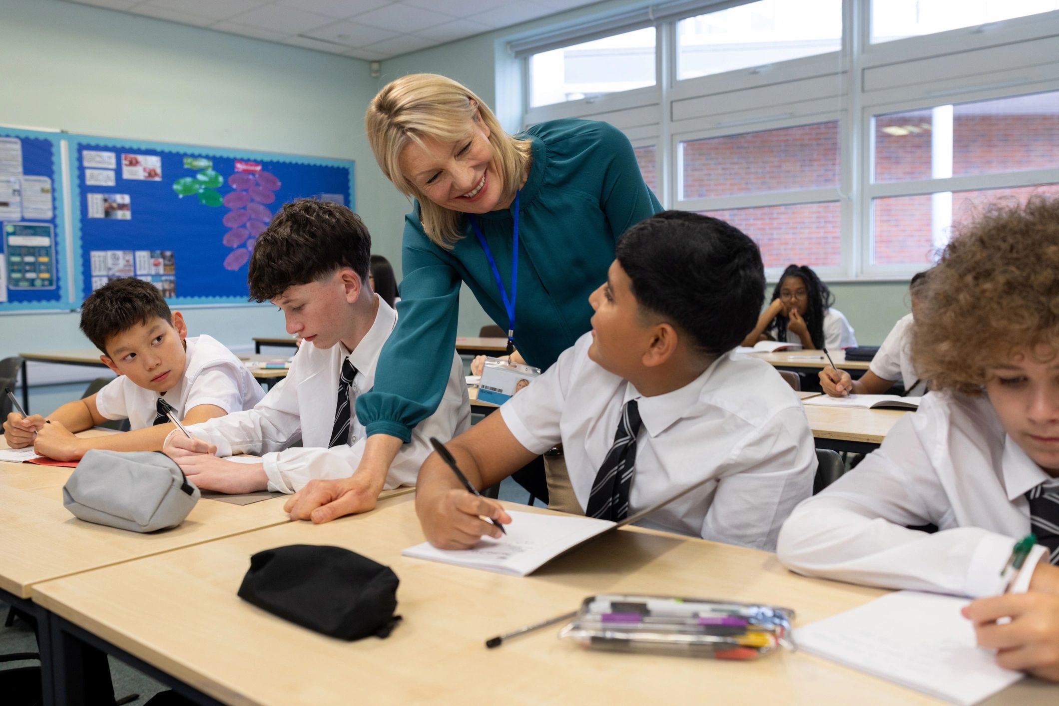 Teacher guiding students in a classroom setting