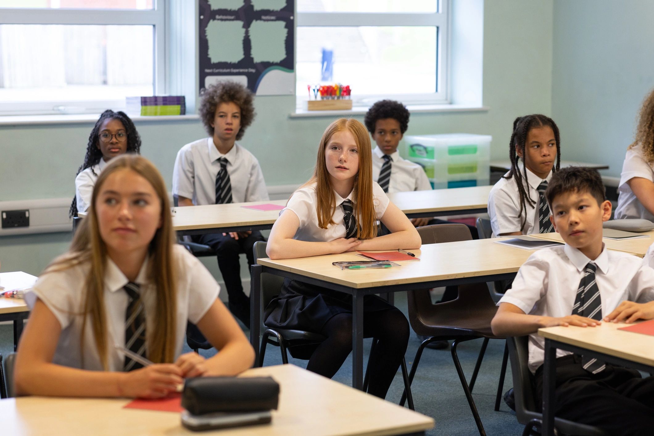 Students listening attentively in a bright classroom