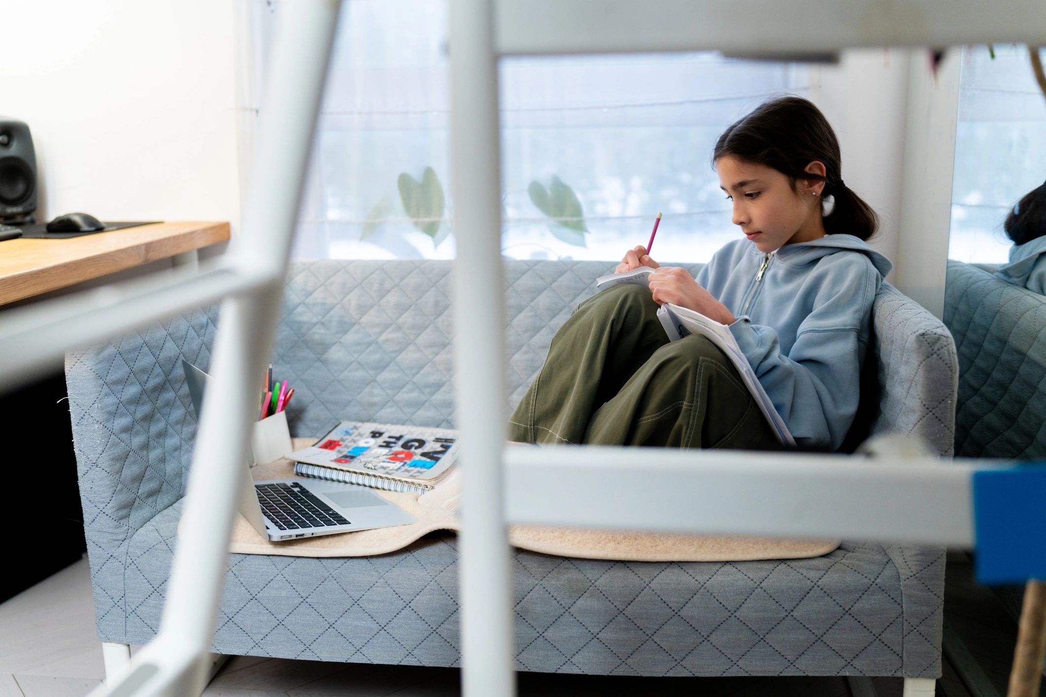 Student studying independently with laptop support