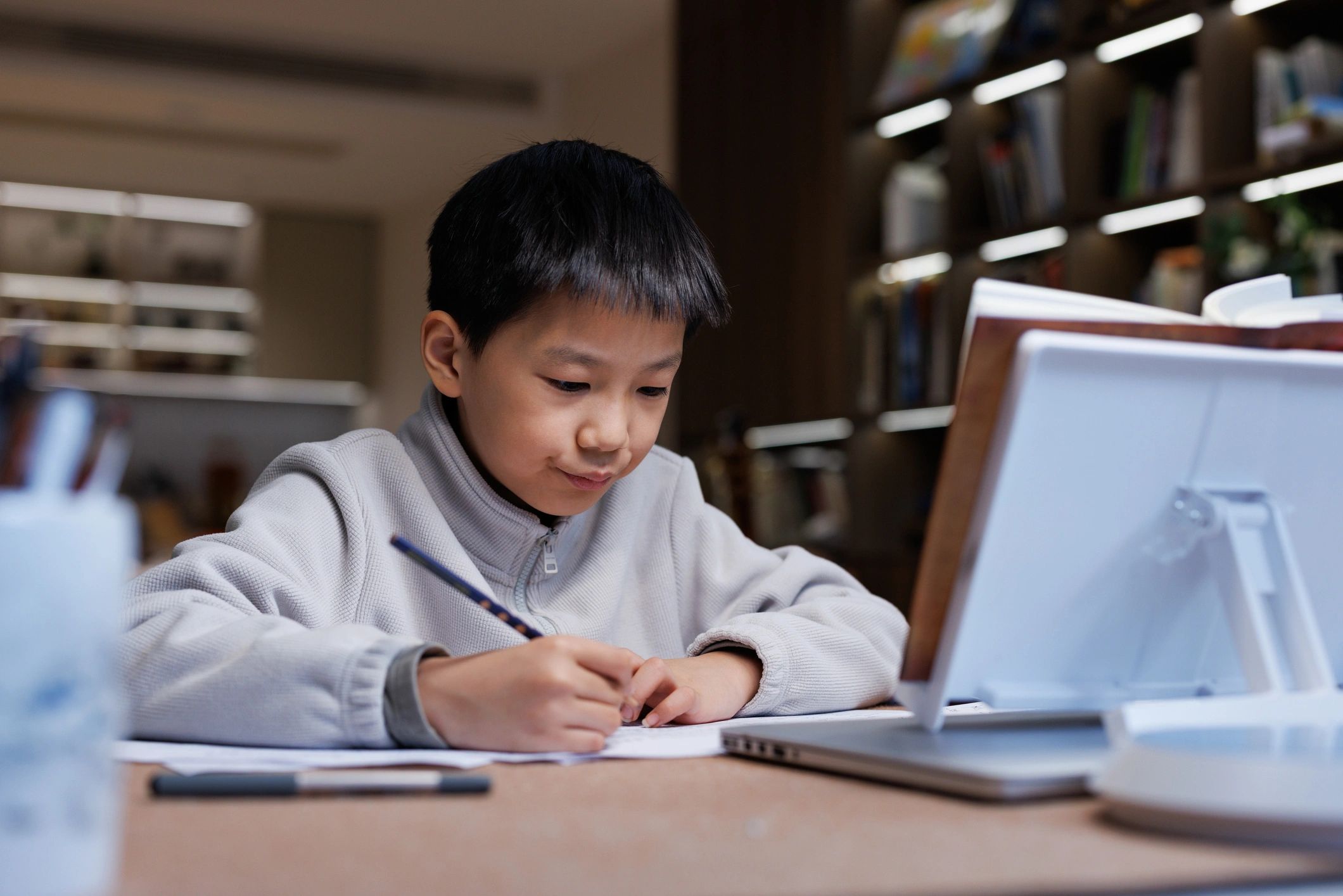 Student doing homework at home with learning materials