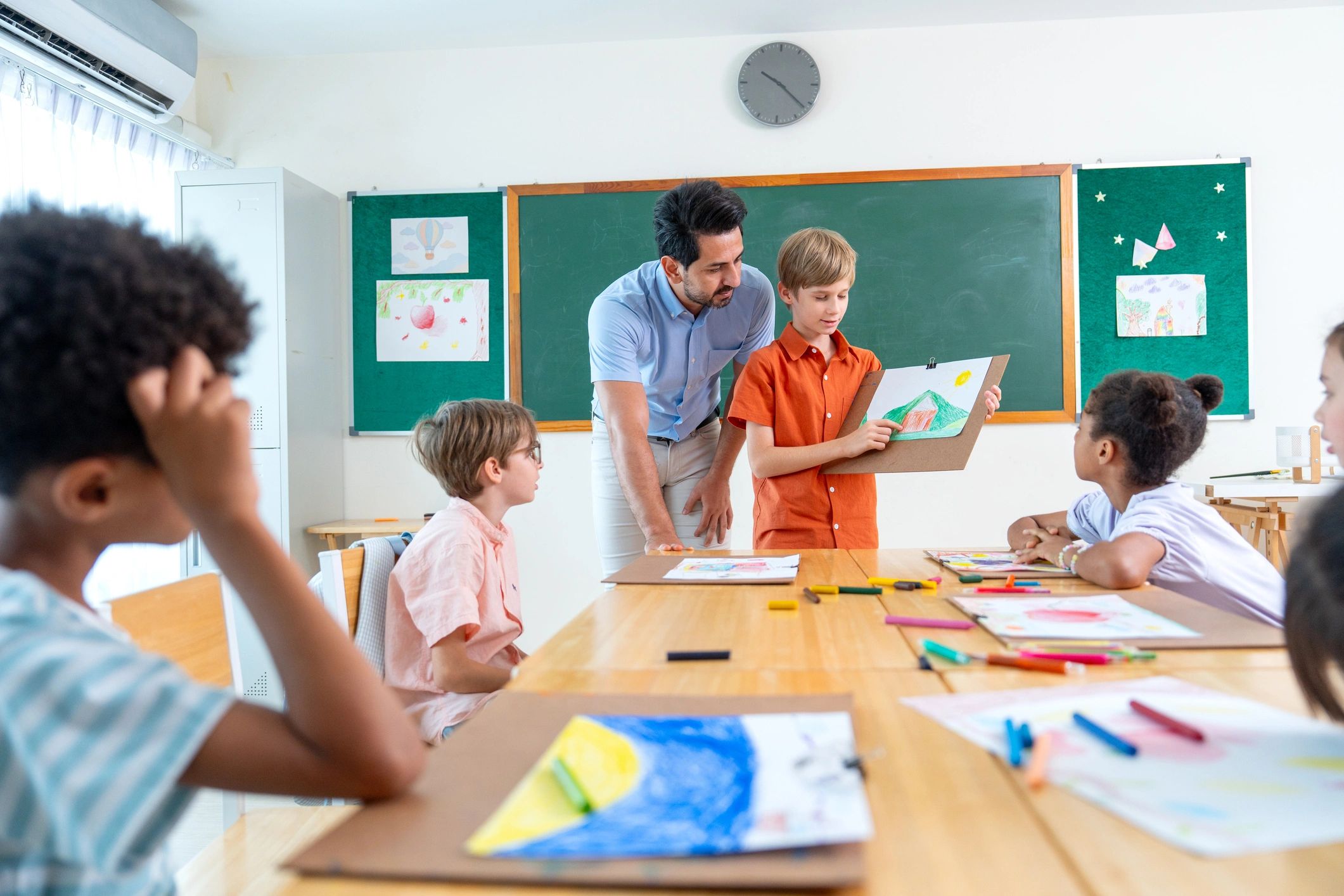 Teacher encouraging a child to present creative work